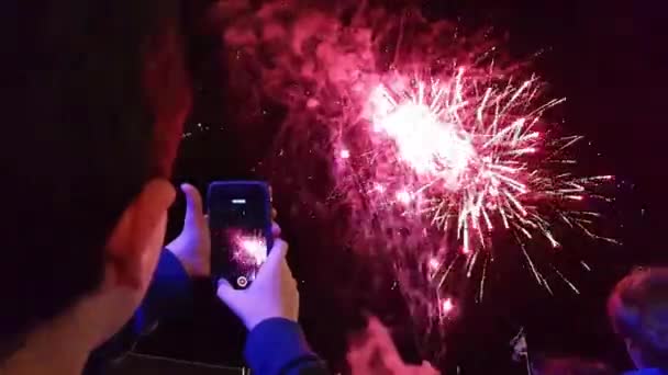 Kid taking video of fireworks shot shot – stockvideo