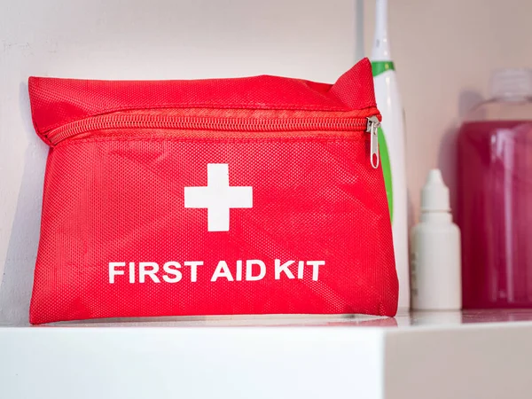 First aid kit placed on shelf in case of injury at home or at work