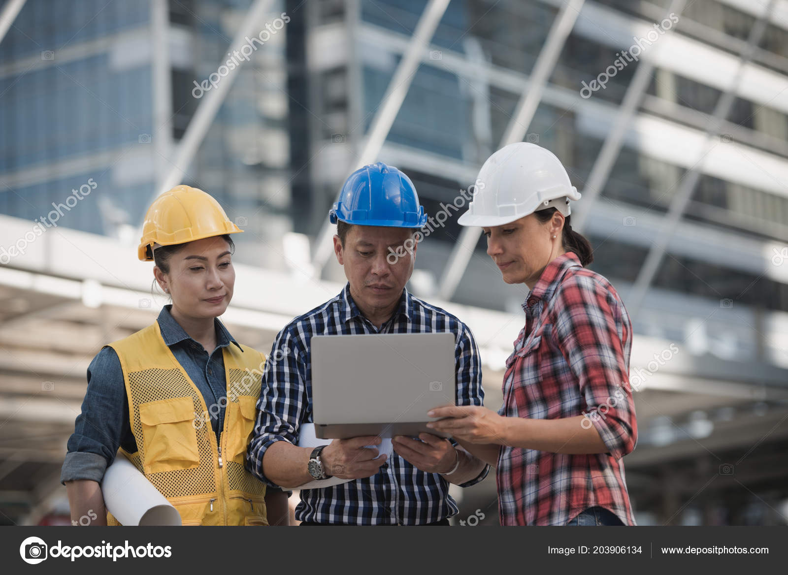 Engineers group consulting at site
