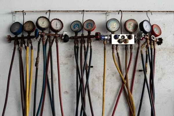 Refrigerator pressure and manometers gauges manometers, for heating ventilation and air conditioning service in various sizes hanging on wall background