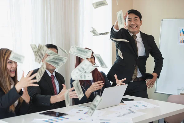 Asyalı iş adamı ve kadın grupları, başarılı iş. Burada çok para var. Ofis masasında bir dizüstü bilgisayar ve belgeyle. iş başarısı konsepti