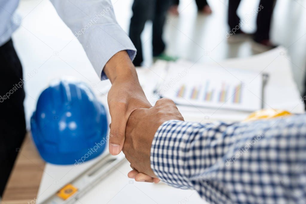 Engineering and businessman shaking hands after successful deal while working in the office center