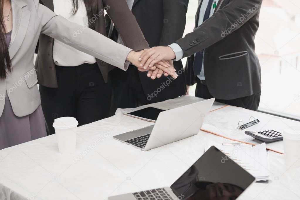 Group Asian Young businessmen join hands for working the job success, Hand coordination, symbolizing the hands to unity and teamwork, meeting, startup , business concept.