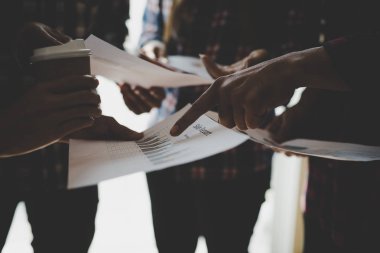 Ekose gömlekli bir kadın ve erkek çalışan bir grup insan iş yapma hakkında konuşuyor / danışmanlık yapıyor. Takım çalışması iş toplantısı