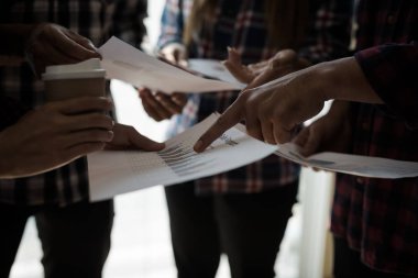 Ekose gömlekli bir kadın ve erkek çalışan bir grup insan iş yapma hakkında konuşuyor / danışmanlık yapıyor. Takım çalışması iş toplantısı