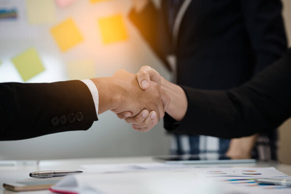 A group of Asian Business handshake of congratulations on meeting the business achieve success.