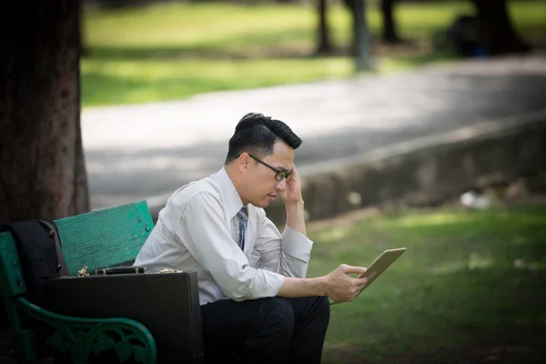 Business man working on digital tablet feel stressed/worry/headache/disappoint during working