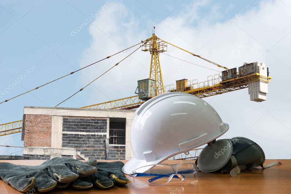Safety in construction, safety standard set on working table. safety of workers on the  construction, construction site background. Always wear safety equipment and personal protective equipment.