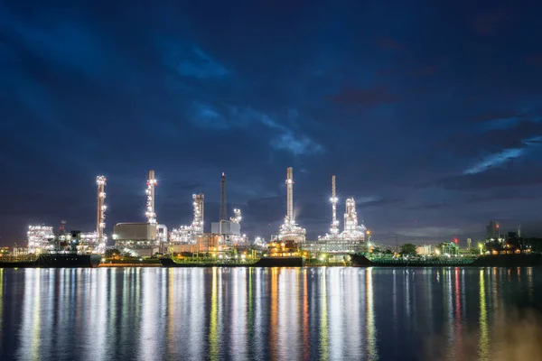 Oil refinery plant of petroleum or petrochemical industry production at twilight night sky