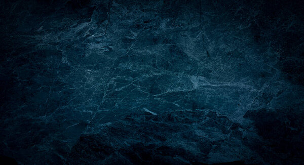 Blue dark wall, stucco, dark concrete. Dark decorative stone. Floodlight. Empty night wall, neon blue light.