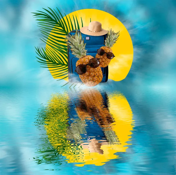 Summer abstract marine background for travel. Pineapple with glasses, a suitcase with a hat, palm branches. Reflection on the water. Blue suitcase and summer wicker hat. Pineapple with glasses. Palm branches. Summer background for travel.