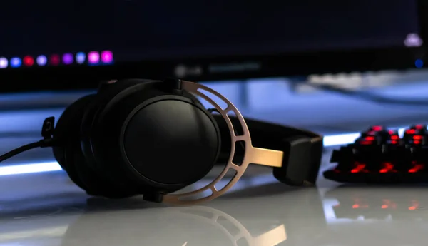 Gaming headphones with mirkophone and neon illumination. Gaming devices, neon lights. Game zone.