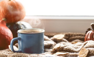 Sonbahar arkaplanı kuru yapraklar, mavi bir fincan kahve. Örgü arka plan, balkabağı, Ekim, Kasım. Sonbahar atmosferi. Sonbahar mevsimi.