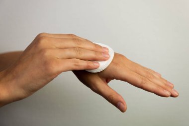 Women cleaning hands with cotton pad clipart