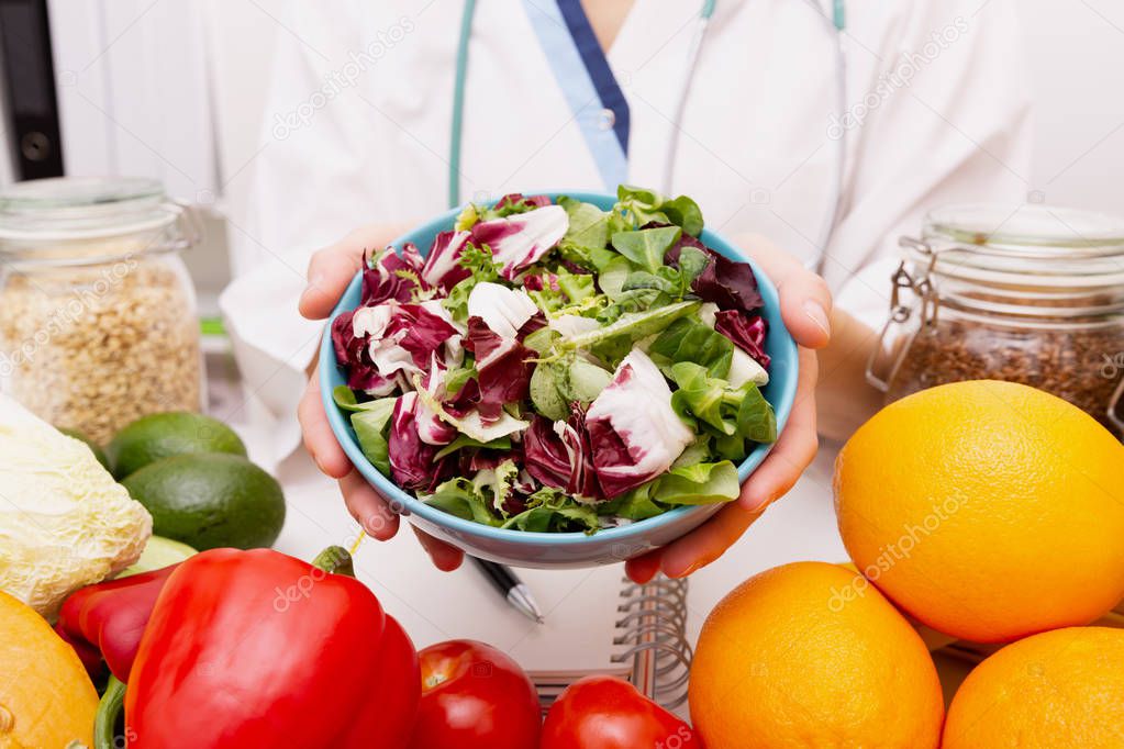 Vegetable diet nutrition and medication concept. Nutritionist offers healthy vegetables diet.