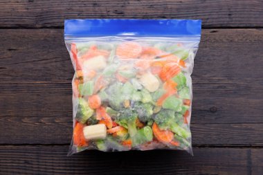 Frozen vegetables in a plastic bag. Healthy food storage concept. clipart