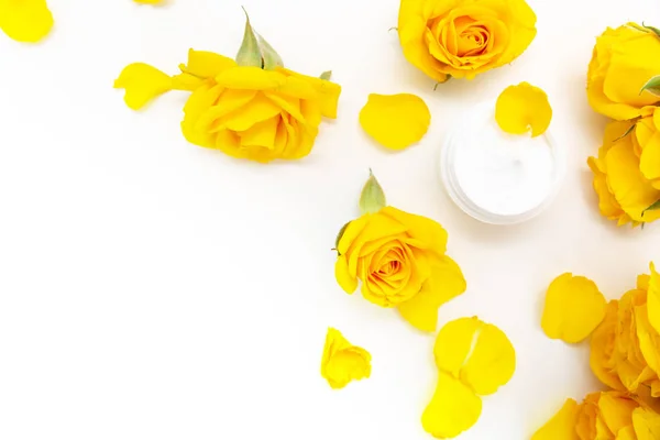 Aromatic botanical cosmetics. Skincare home spa treatment with yellow petals, rose blossom, natural face cream