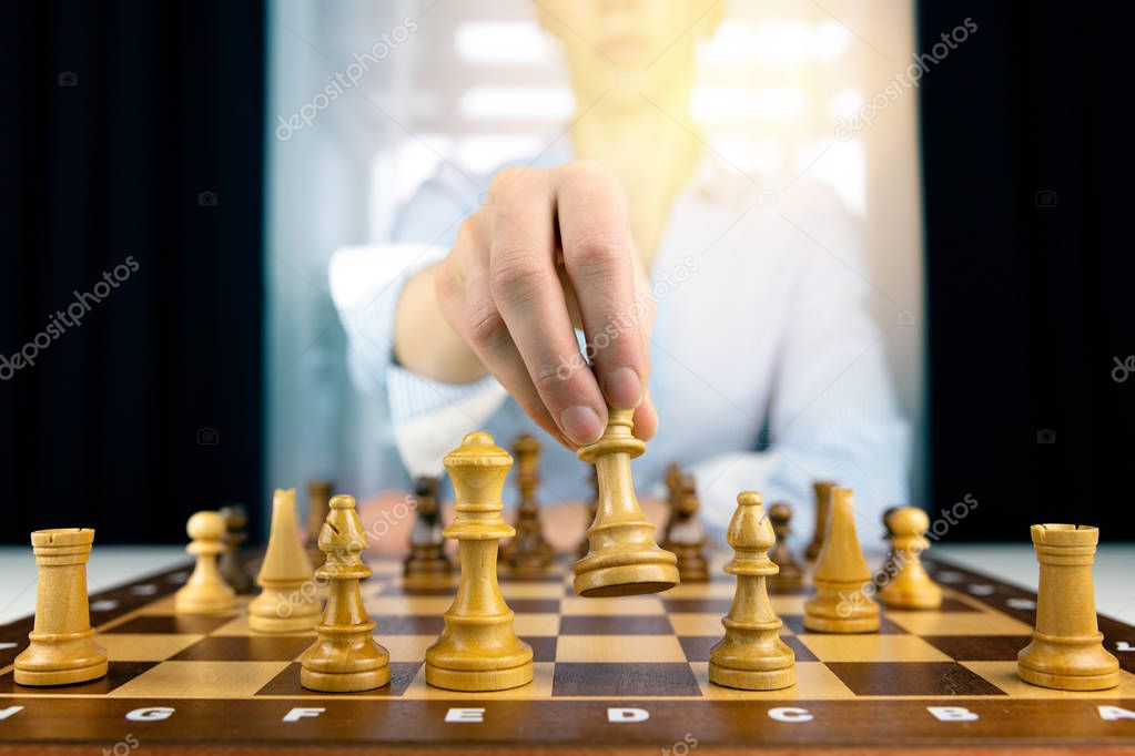 hand of businesswomen moving chess figure in competition success play. strategy, management or leadership concept