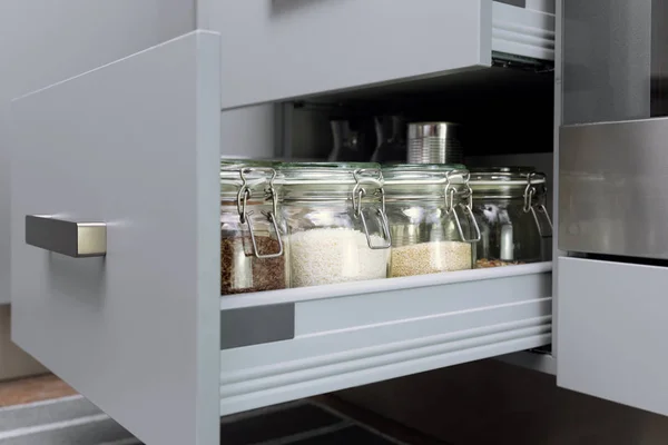 Various seeds in storage jars in hutch, white modern kitchen in