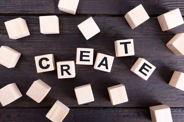 Word CREATE written on wooden blocks. Idea and new design concep