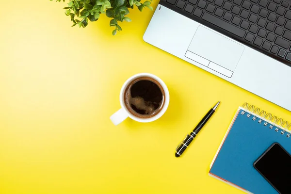 Laptop, Notebook, smartphone, kaffe och penna på gul bakgrunds — Stockfoto