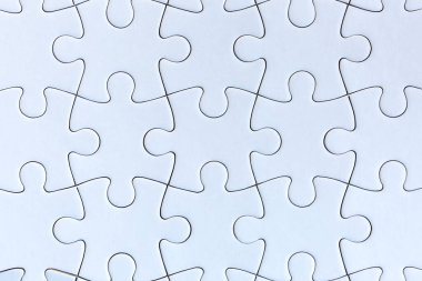 Gri arkaplanda beyaz yapboz parçaları