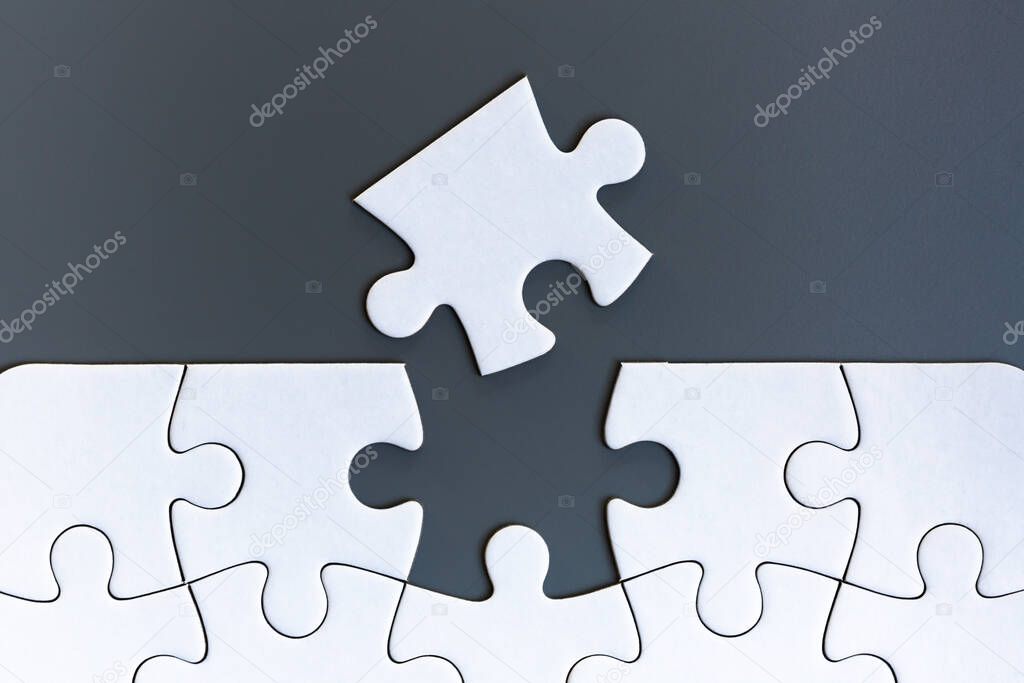 White jigsaw puzzle pieces on gray background