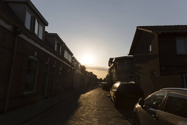 A glowing sunset shining down on a streetscape.