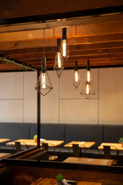Unique lighting fixtures inside modern restaurant interior.
