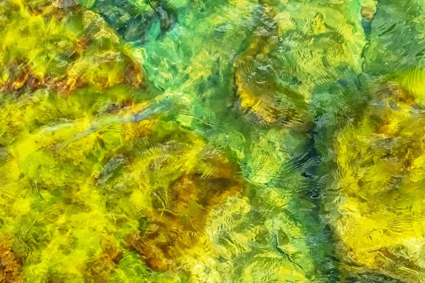 Clear water in colorful colors in abstract patterns