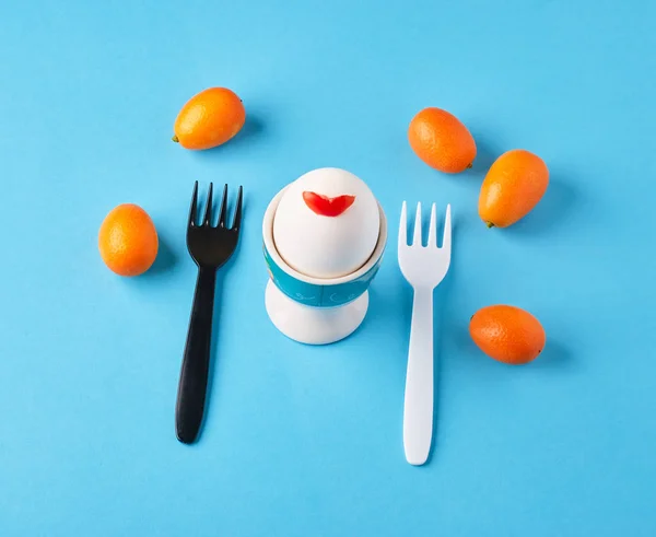 Royal egg with fruit for breakfast on a blue background