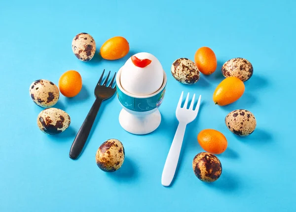 Royal egg with fruit for breakfast on a blue background