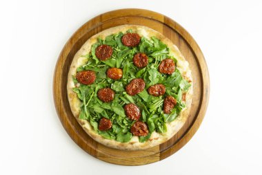 Rucula ve beyaz arka plan üzerinde kuru domates büyük pizza