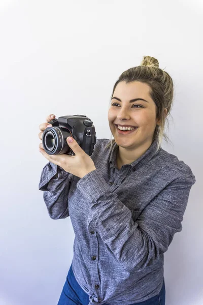 Woman photographer standing with camera photographing