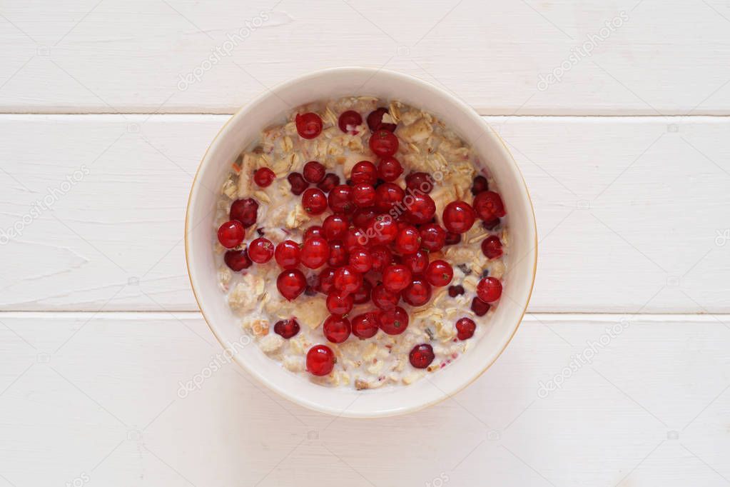 breakfast bowl of muesli with fresh redcurrant berries