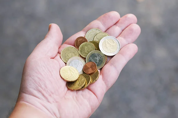 Handful of small loose pocket change euro cent coins in palm of hand — Stock Photo, Image