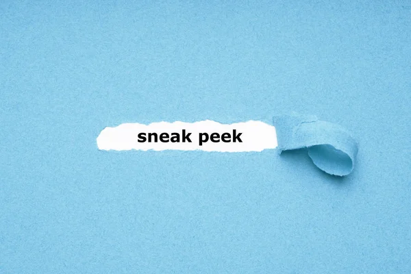 Sneak peek text revealed by peeling off torn blue paper background — Stock Photo, Image