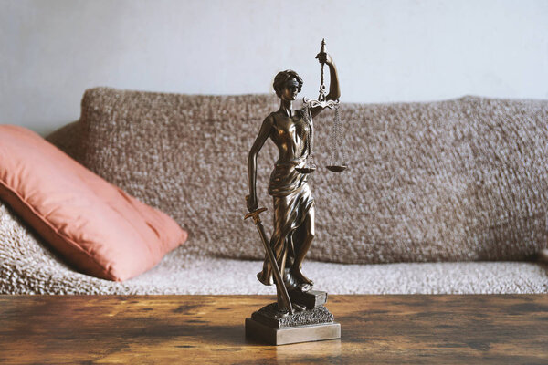 lady justice or justitia statue on table - landlord and tenant law