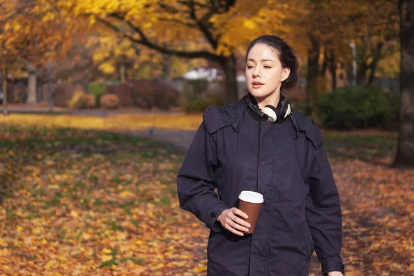 Junge Frau genießt Spaziergang durch Park im Herbst — Stockfoto