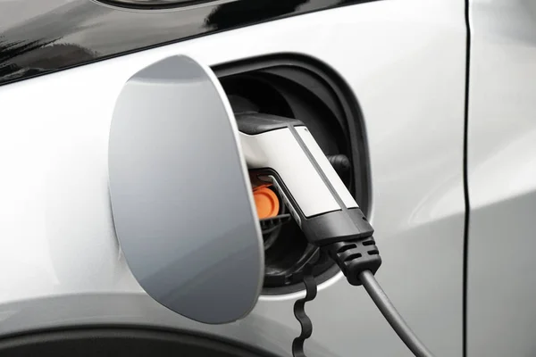 EV or Electric car at charging station plugged in — Stock Photo, Image