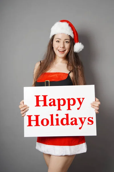 Miss santa wishing happy holidays — стоковое фото