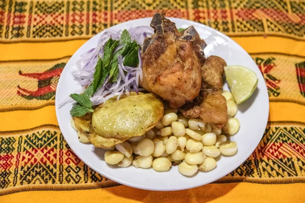 Peruvian dish, pork meat with corn, potatoes and red onion salad. Very popular menu in Peru.
