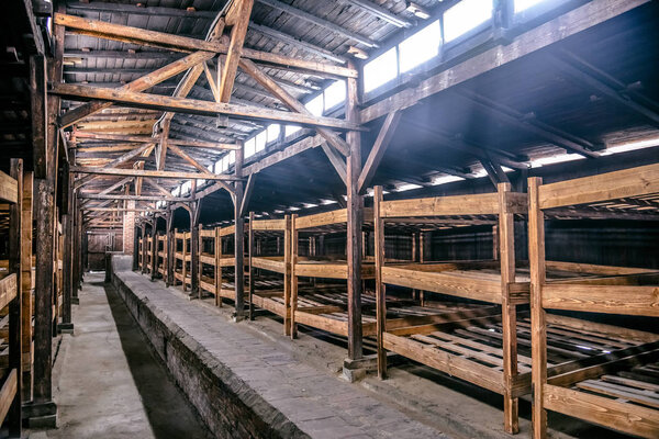 Oswiecim / Poland - 02.15.2018: Prisoner's wooden beds, bunks inside barrack in Auschwitz Birkenau Museum.