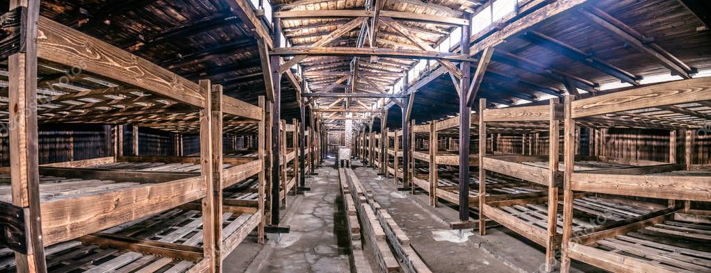 Oswiecim / Poland - 02.15.2018: Prisoner's wooden beds, bunks inside barrack in Auschwitz Birkenau Museum.