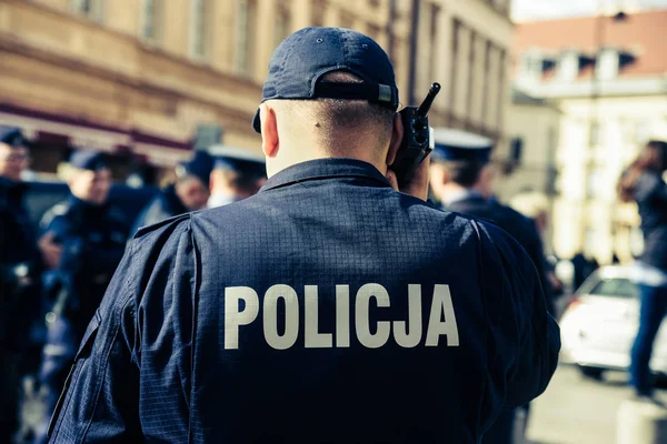 Police sign/logo on the back of the police uniform. Policeman.