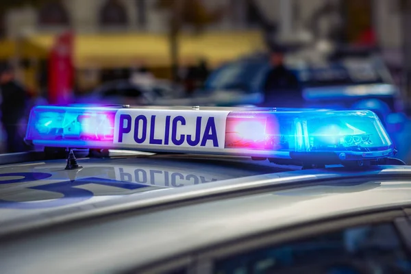 Police car rooster with red and blue lights and sign.