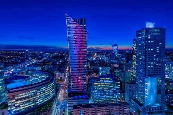 Warsaw cityscape. Panoramic view on the illuminated city buildings at night in capital of Poland. Urban nightscape. 