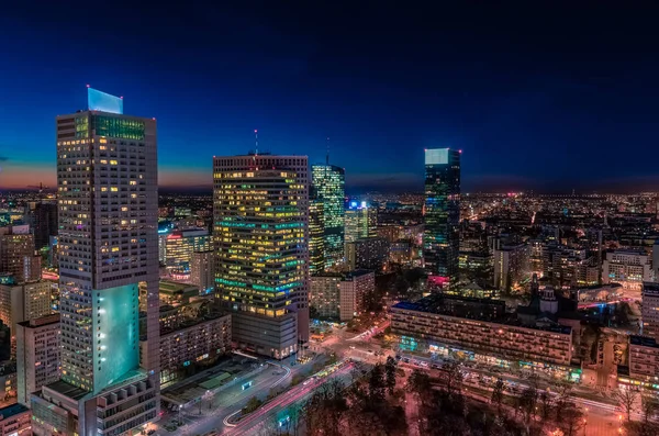Warsaw cityscape. Panoramic view on the illuminated city buildings at night in capital of Poland. Urban nightscape. 