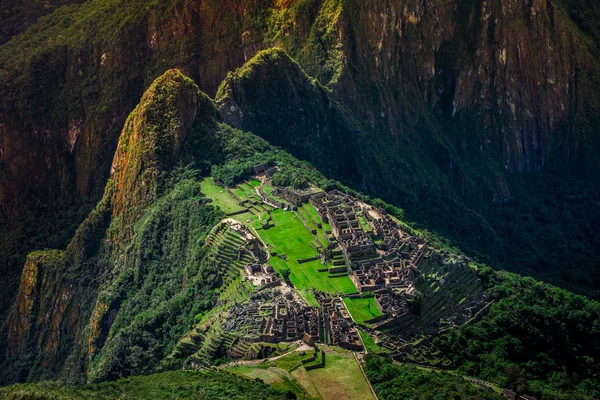 Unique aerial view on the Machu Picchu / Huayna Picchu mountain with Incan sacred city ruins during the sunset.