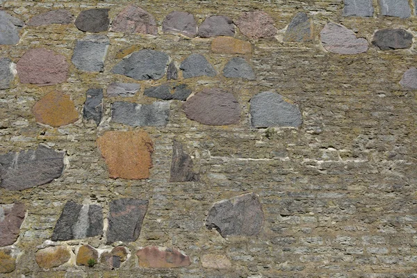 Wysoki Mur Dużych Kawałków Kolorowych Kamienia Wśród Mniejszych Szarej Cegły — Zdjęcie stockowe